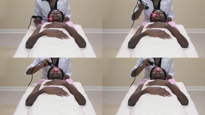 接受激光面部治疗的年轻非洲妇女