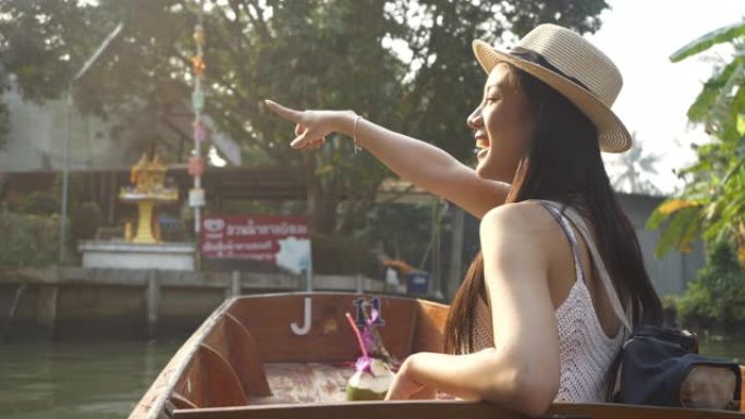 慢动作美丽的亚洲女性游客戴着帽子坐在泰国曼谷丹诺萨杜阿克的行旅行出租车船景点。