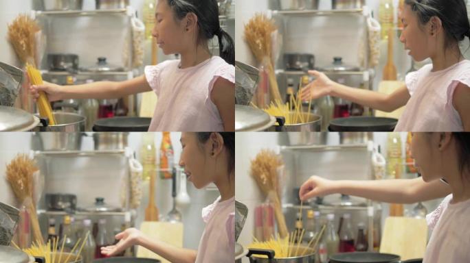 快乐的亚洲女孩和她的兄弟在家一起煮意大利面Carbonara酱，生活方式理念。