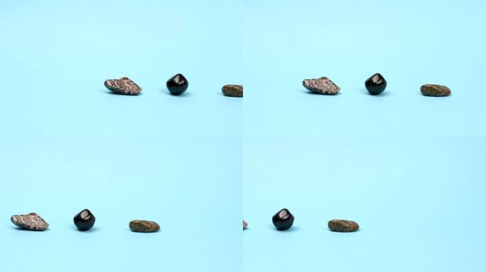 豹纹碧玉，石榴石，蓝色背景上的unakite。