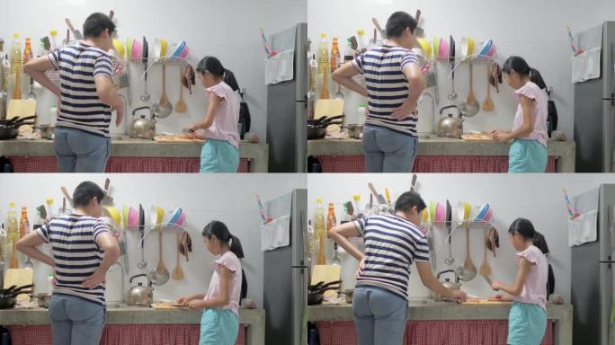 快乐的亚洲女孩和她的兄弟在家一起煮意大利面Carbonara酱，生活方式理念。