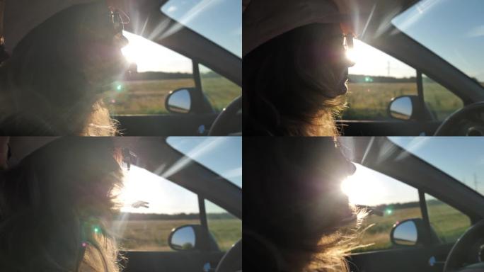 年轻女孩开车旅行，在太阳耀斑上跳舞很开心