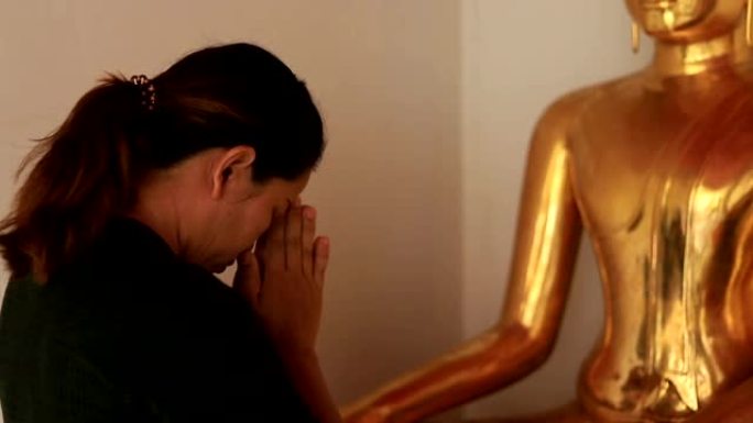 亚洲妇女在泰国曼谷Wat Pho寺庙与佛陀一起祈祷