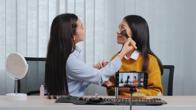 亚洲美容影响者录制视频博客在线广播与化妆化妆品在线影响者在社交媒体概念上直播病毒视频。