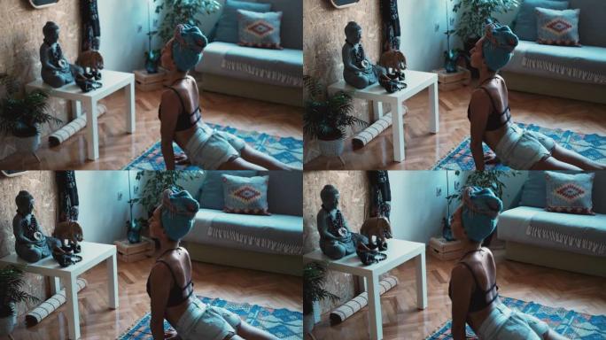 女性瑜伽士在家做瑜伽并练习朝上的狗姿势的特写
