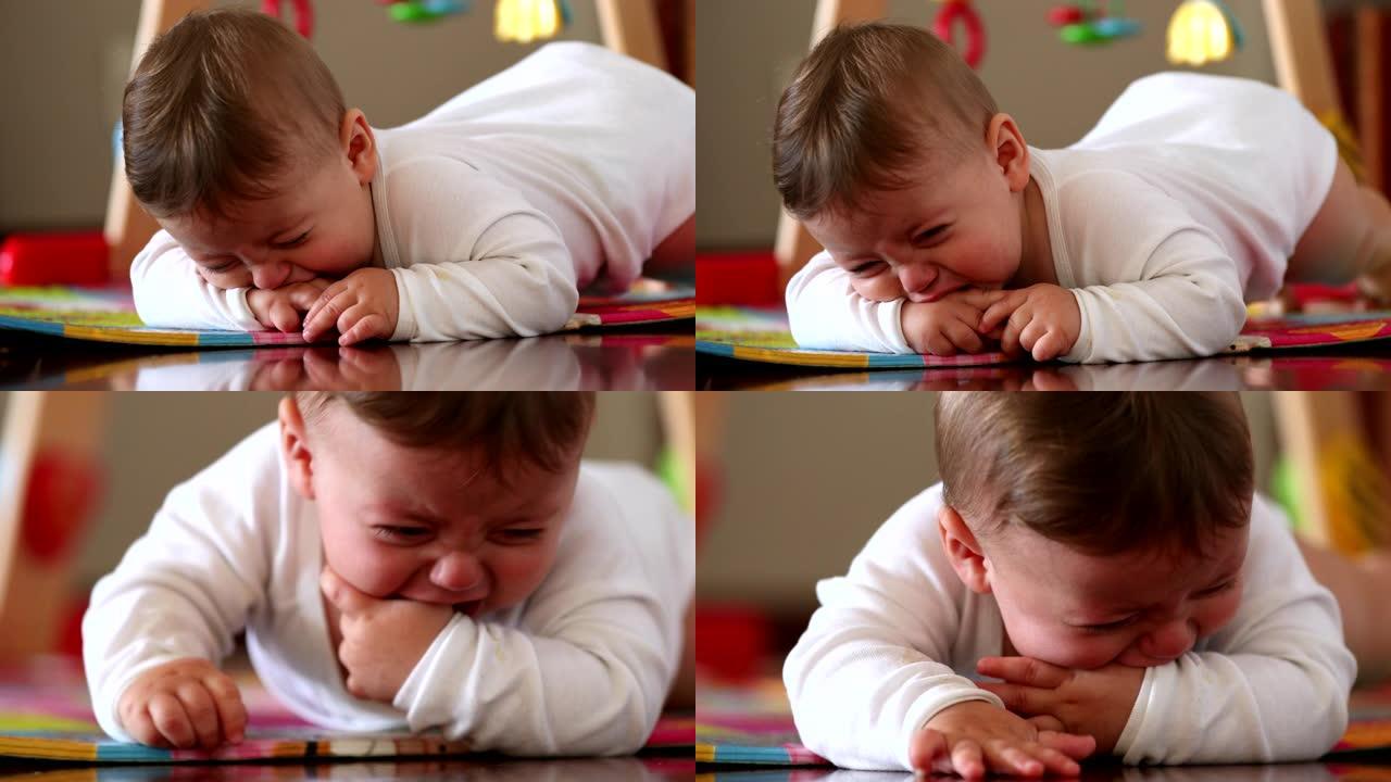 心烦意乱的婴儿哭泣，疲倦的愤怒的一岁小孩躺在游戏垫上发脾气