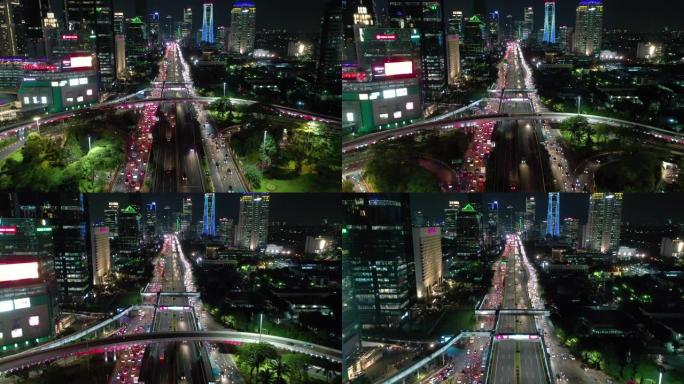 雅加达市市中心夜间照明交通街路口空中全景4k印度尼西亚