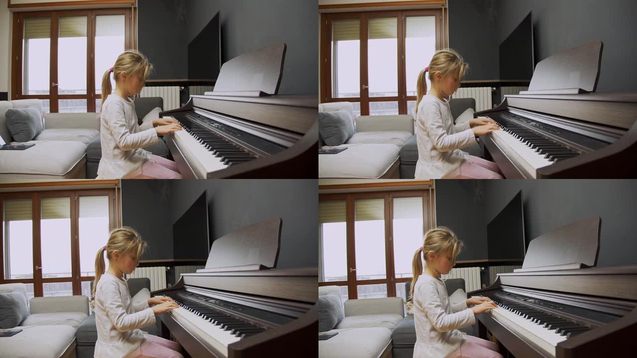 小女孩在家弹钢琴。孩子在客厅弹钢琴。孩子在家学习钢琴。音乐课，中景侧视图。
