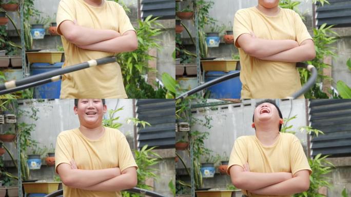 亚洲青春期男孩玩呼啦圈在家后院锻炼，生活方式概念。
