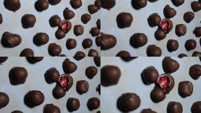 新鲜红色和闪亮的新鲜覆盆子蘸自制黑白巧克力的慢动作视频