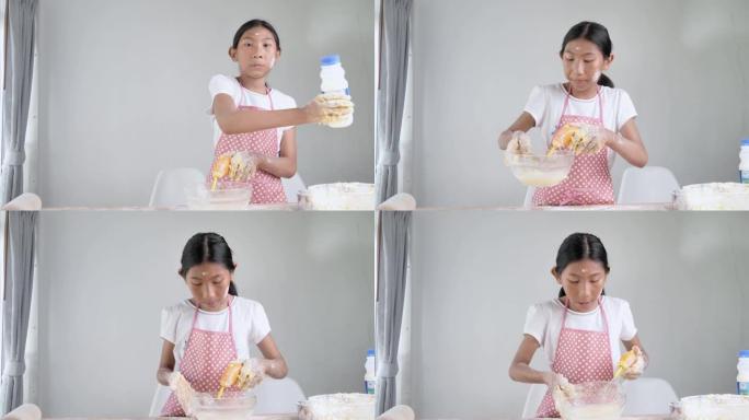 亚洲女孩在家自己做面包或比萨饼面团，生活方式概念。
