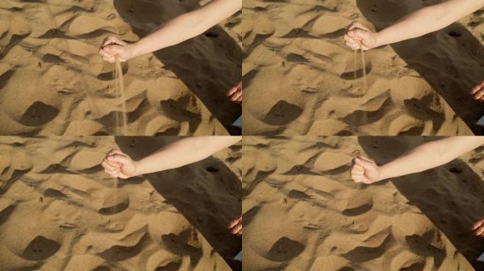 沙子背景上女人手摇摇欲坠的万向节照片