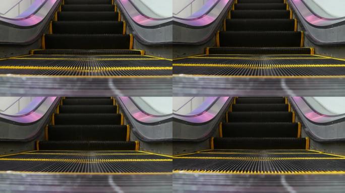 现代自动扶梯楼梯的低角度环形透视图。自动电梯机构。楼梯上的黄线被紫光照亮。未来的空机械楼梯直线移动