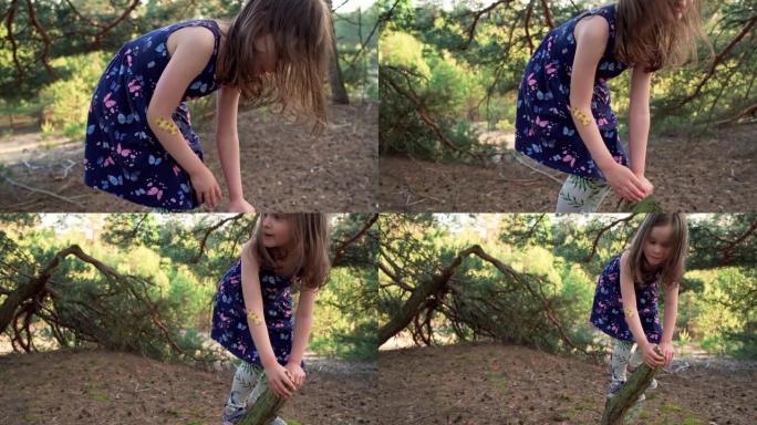 穿着夏装的小女孩在森林里爬树