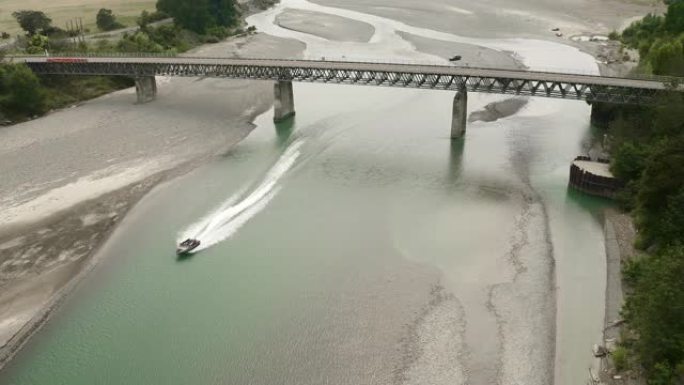 空中: 快艇在桥下沿莫图河航行。位于新西兰北岛东开普。