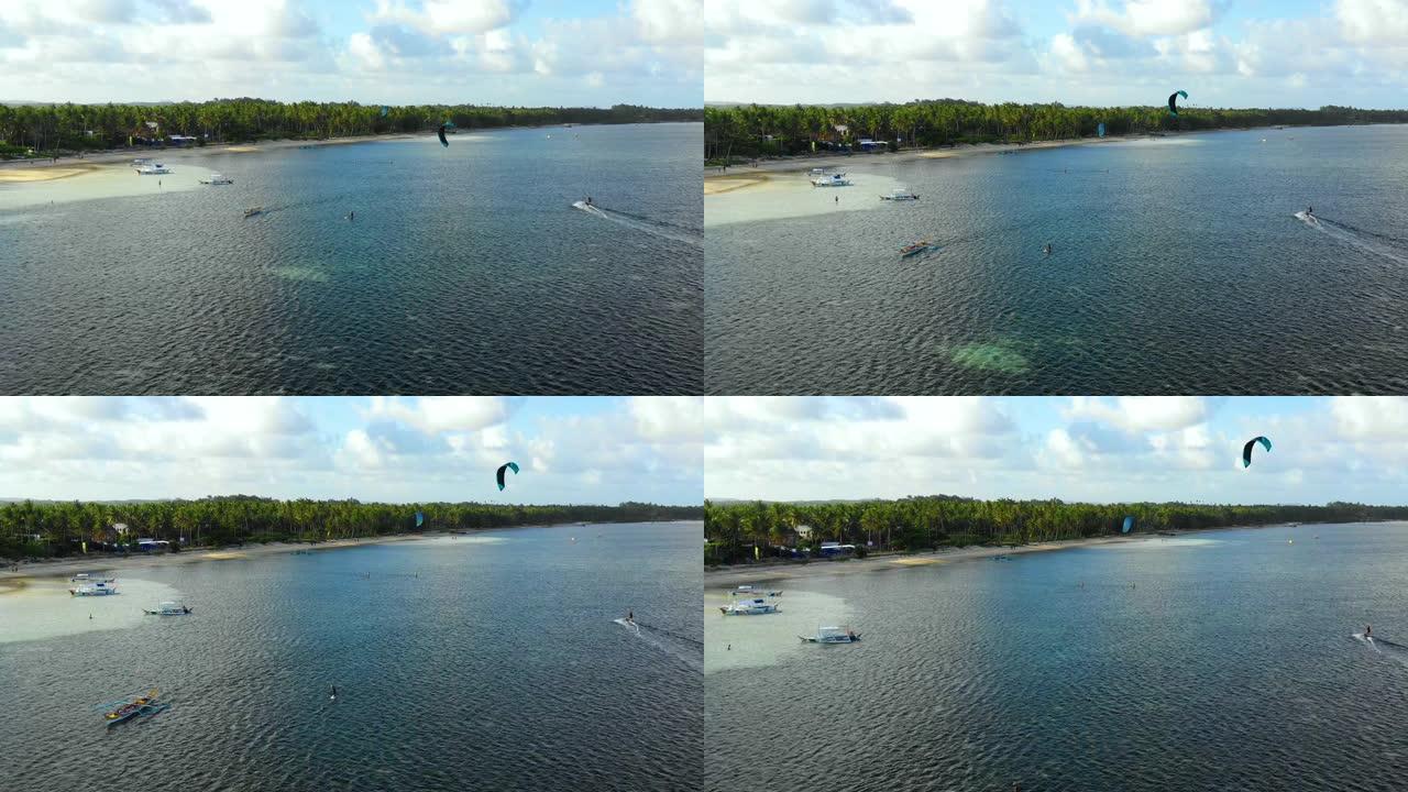 人们在海洋里做风筝冲浪杂技。暑假完美的休闲活动，地平线上到处都是海洋-无人机4k的鸟瞰图