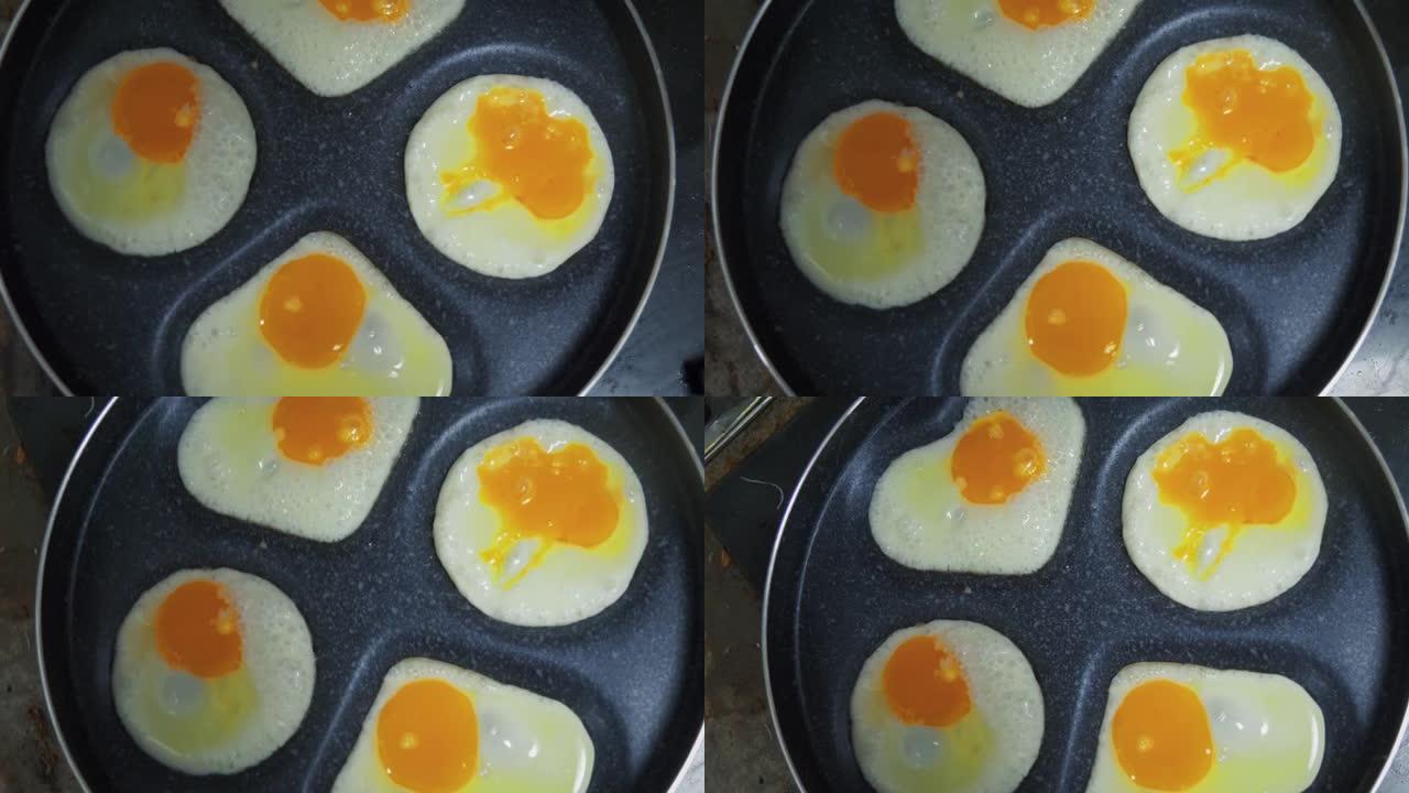 情人节用心形迷你平底锅煮煎蛋。慢动作镜头