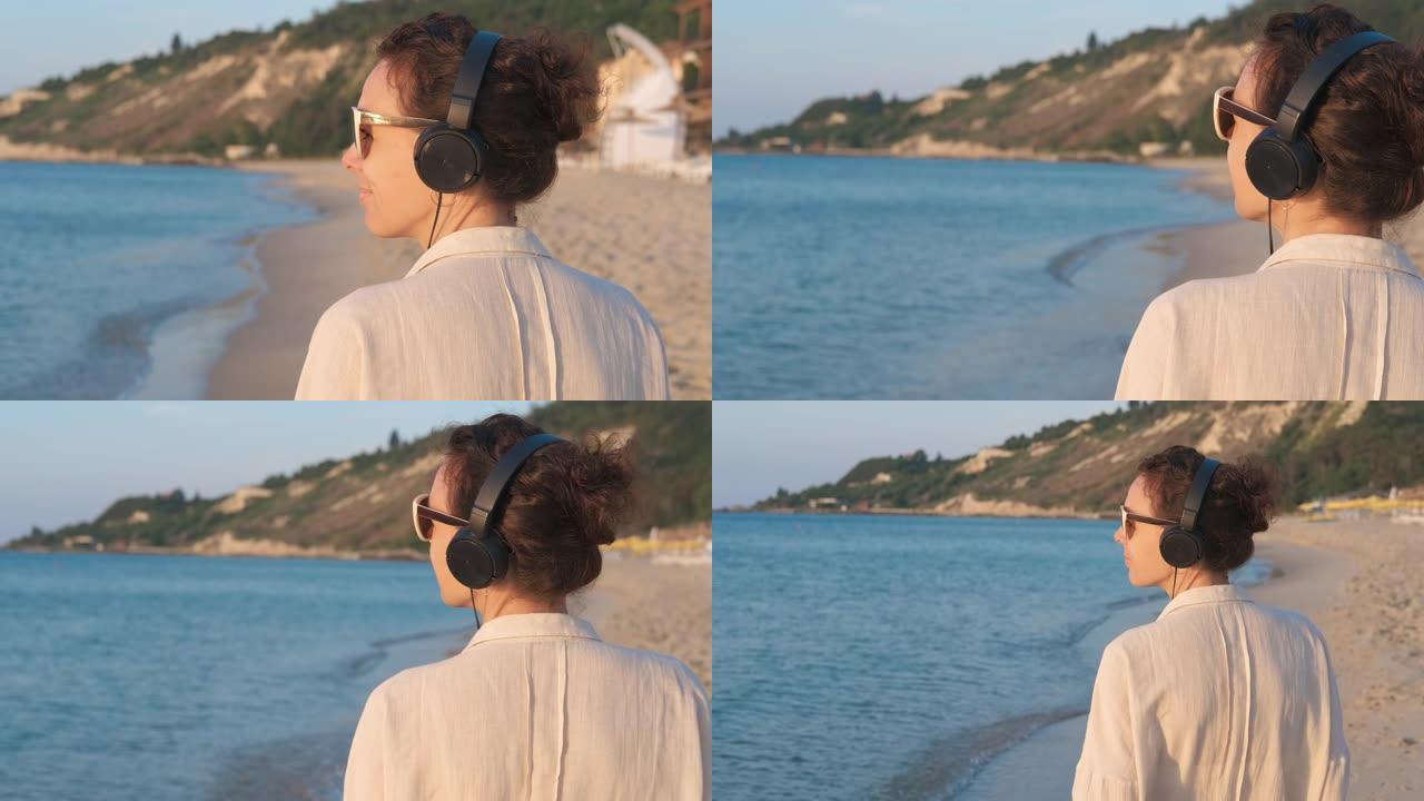 海边戴耳机的女人。