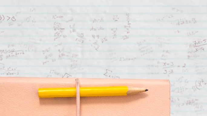 铅笔和书籍反对白纸上的数学方程式