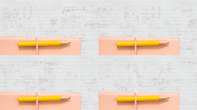 铅笔和书籍反对白纸上的数学方程式