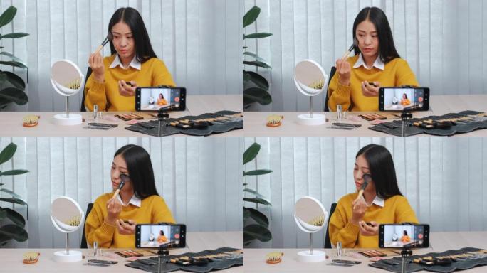 亚洲美容影响者录制视频博客在线广播与化妆化妆品在线影响者在社交媒体概念上直播病毒视频。