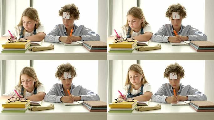 男孩和一个女孩坐在教室的同一张桌子上。女孩认真写，男孩从笔记本女孩那里注销