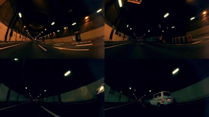 在城市公路隧道拍摄的观点。黄昏时在城市公路上行驶，穿过城市交通。