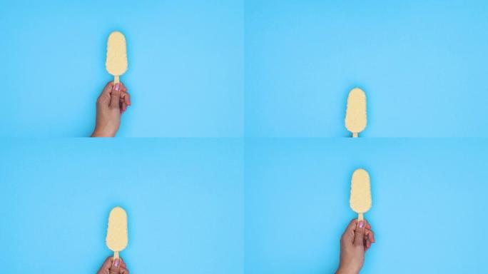 女人手中的白巧克力冰淇淋以蓝色主题出现。停止运动