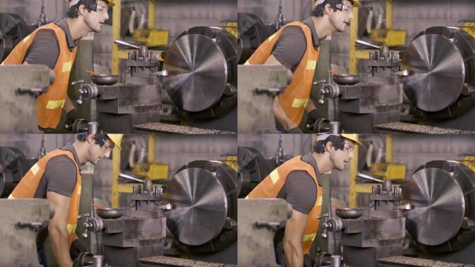工厂工人/工程师在车间努力工作，工程师/工人戴着安全镜和安全帽大型机械机械重型工业工厂。