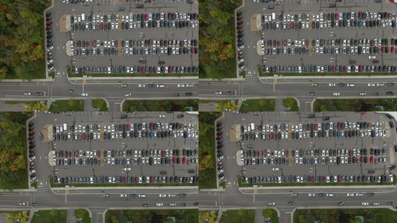 垂直高架无人机拍摄繁忙的停车场，车内行驶