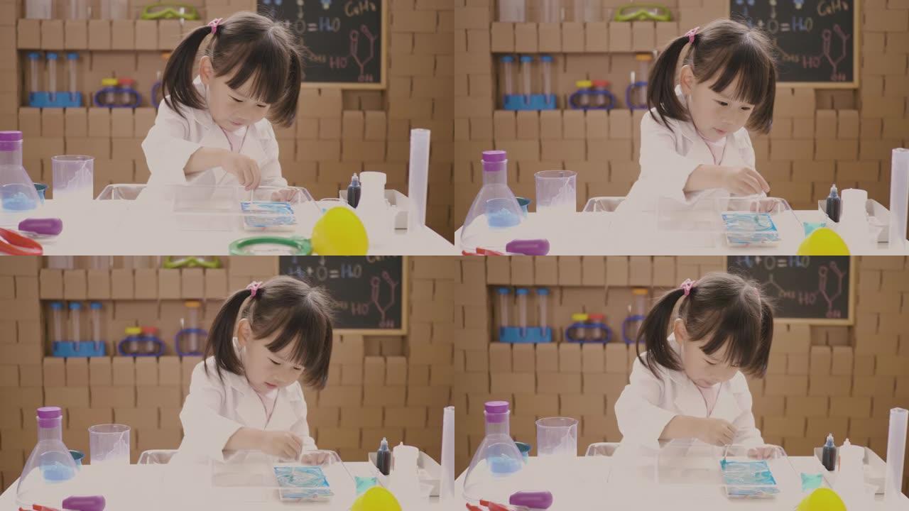 蹒跚学步的女孩玩扎染牛奶科学实验