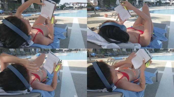 使用耳机，看书，在海滩上晒日光浴