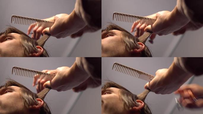 理发师手拿着剪刀和梳子表演理发