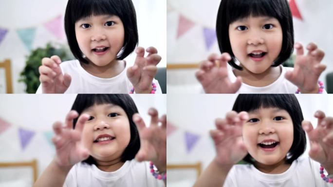 慢动作快乐的亚洲小女孩假装怪物做鬼脸