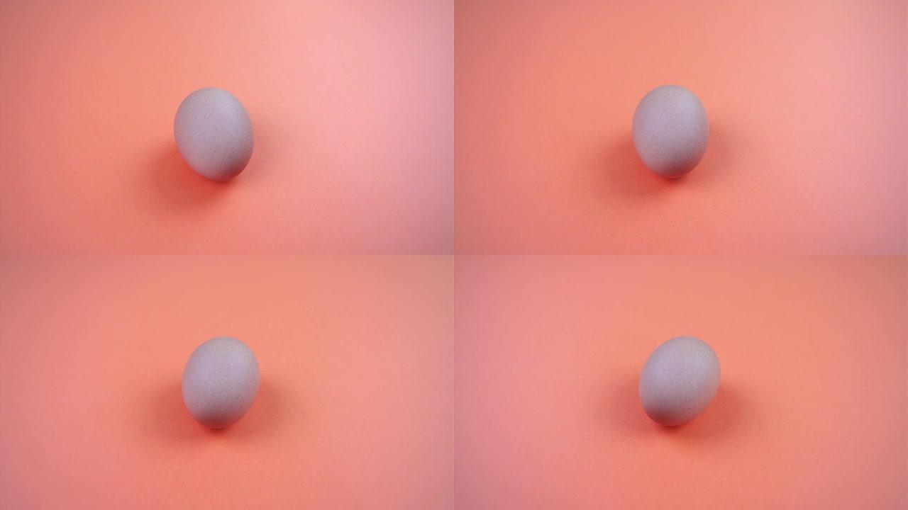 新鲜的鸡蛋躺在明亮的粉红色表面特写上