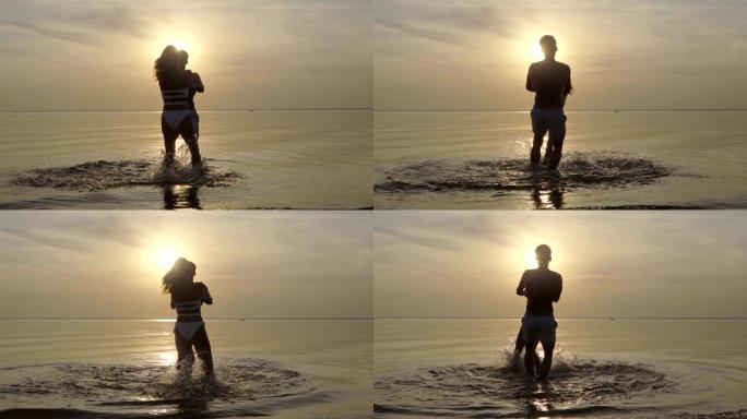 这对夫妇在日落背景上在水面上旋转。慢动作