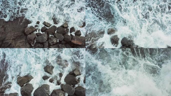 海浪撞击岩石的鸟瞰图泡沫和飞溅美丽的过渡