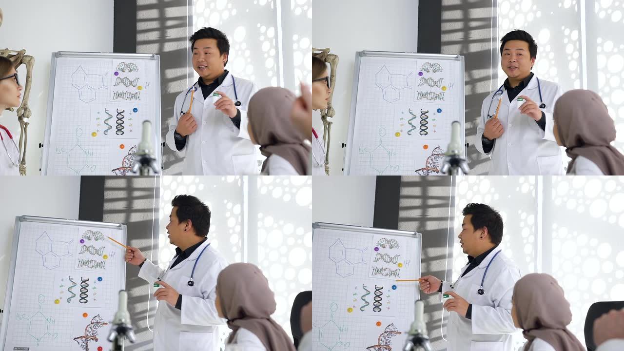 韩国男医生的肖像为他的多种族医生-伙伴讲授如何将不同的化学化合物结合起来解决医学问题