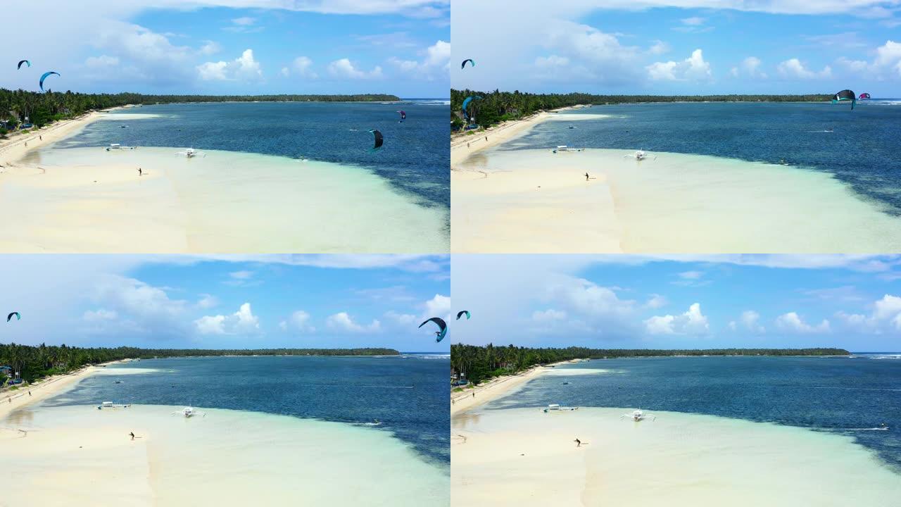 人们在海洋里做风筝冲浪杂技。暑假完美的休闲活动，地平线上到处都是海洋-无人机4k的鸟瞰图