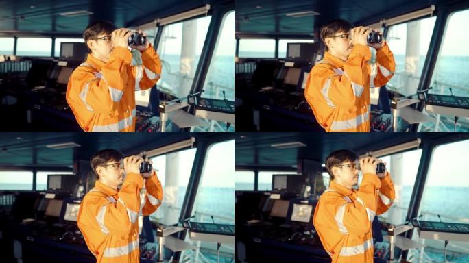 通过双筒望远镜观察船只或船只桥梁上的菲律宾甲板人员