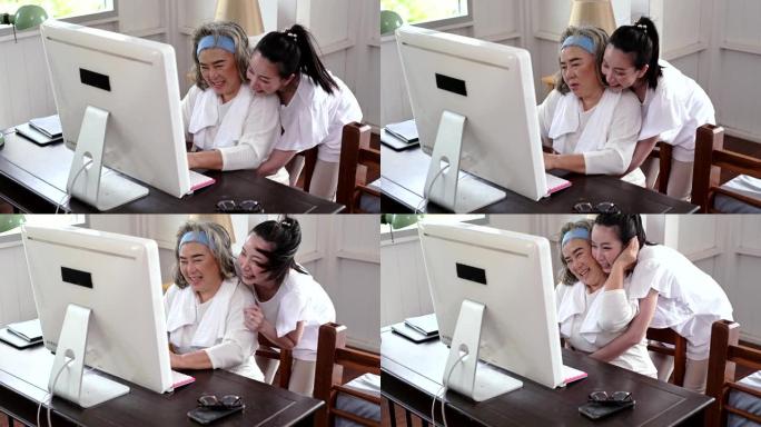 亚洲年轻女子向一名亚洲老高级女子教授电脑