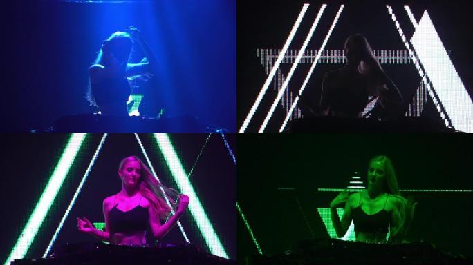 性感的女孩DJ在俱乐部的灯光和声音的音乐会上播放转盘电子舞曲和舞蹈。概念音乐家在夜总会的舞台上表演。