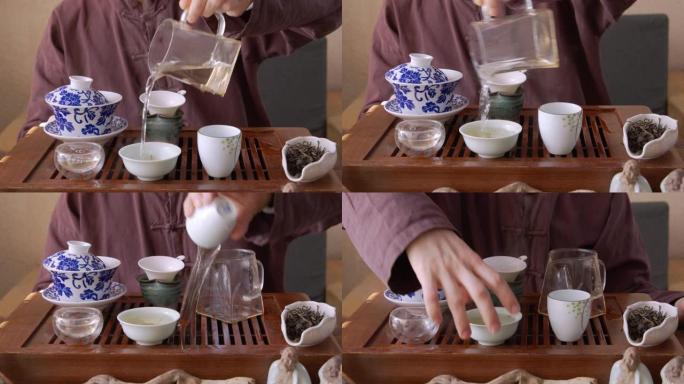 茶师傅在餐具里浇热水的前视图