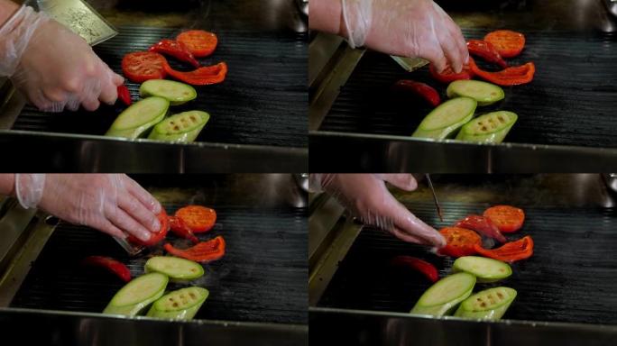 餐厅厨师烤西红柿，辣椒和西葫芦的特写镜头。