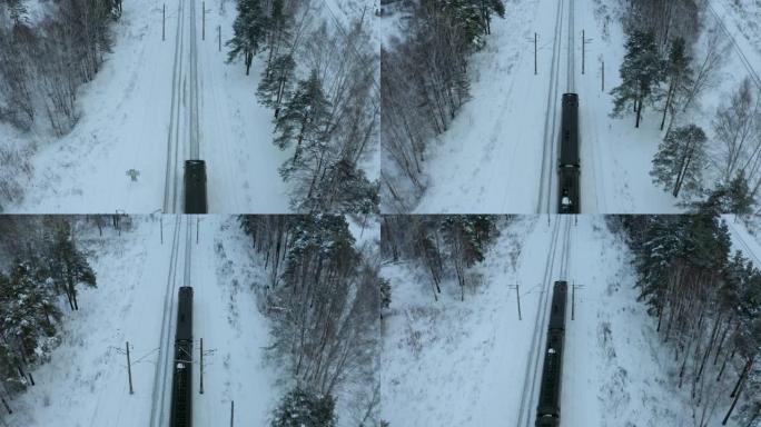 日落时分，通勤火车的空中迎面驶过白雪皑皑的冬季松树林