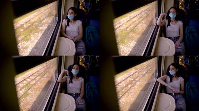 火车乘客戴着防护面罩，坐着向窗外看。