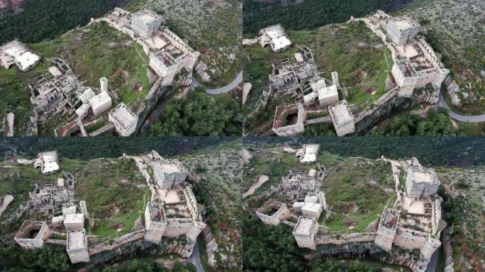 叙利亚萨拉丁城堡。叙利亚战争后一片废墟的山顶上美妙的中世纪城堡 -- 无人机的鸟瞰图