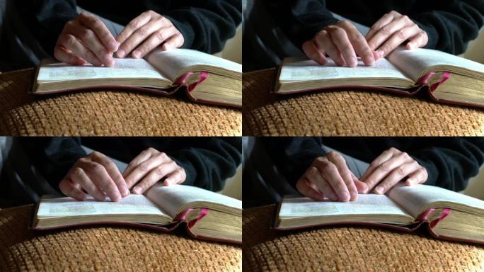 女人读圣经，特写镜头。手指一行一行地走。