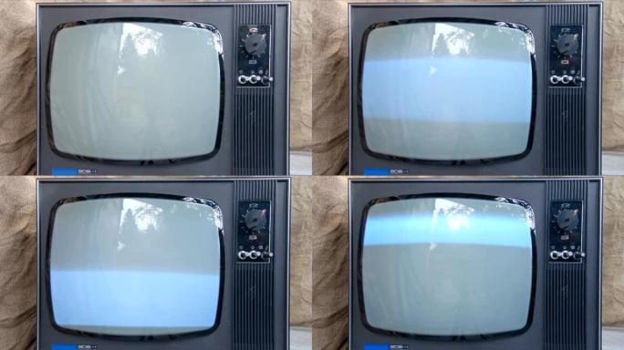 旧电视是用手打开的。发光复古电视屏幕闪烁