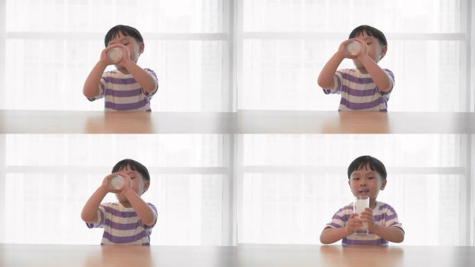 小男孩喝一杯牛奶